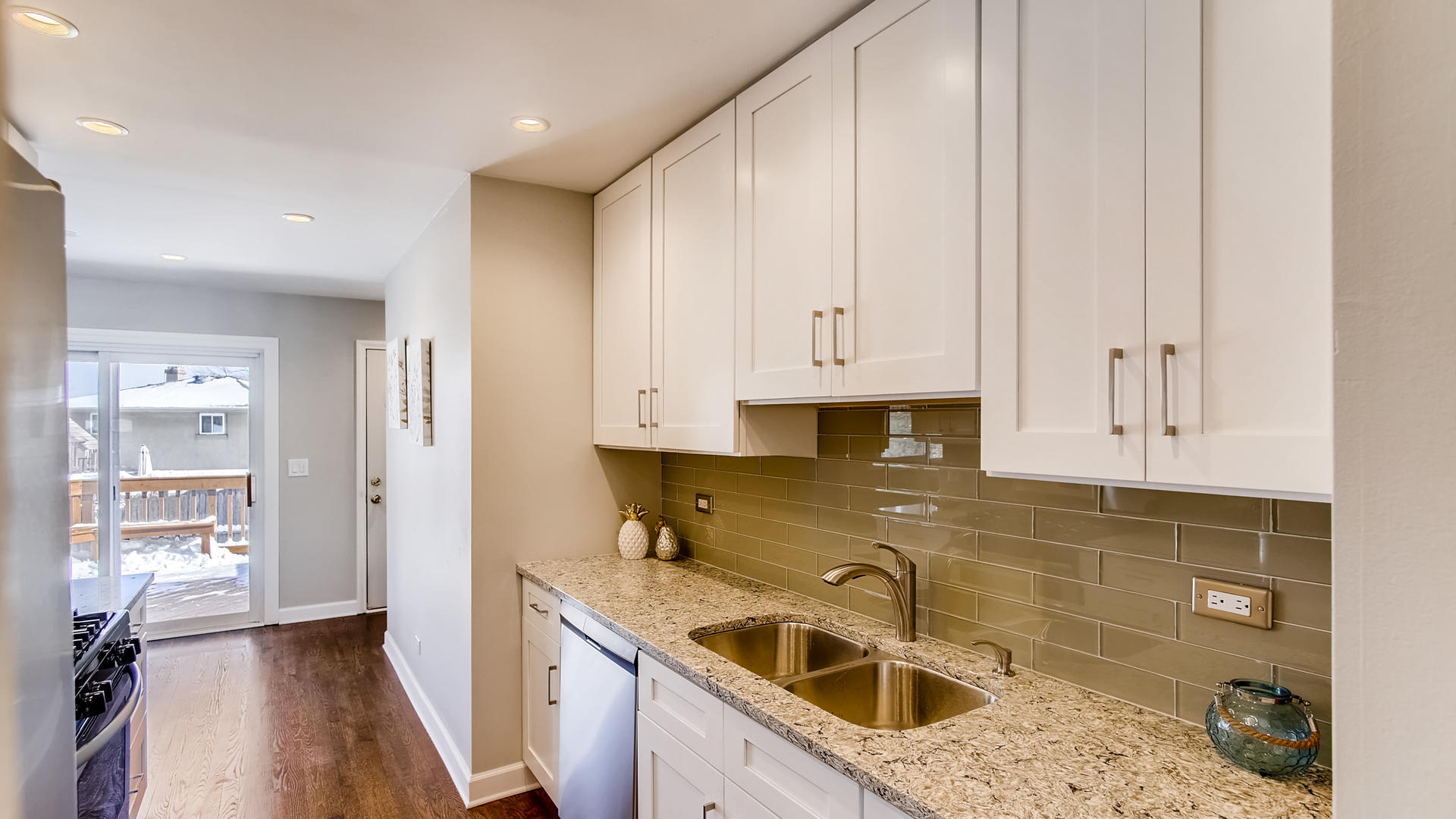 1229 Honey Hill Road Addison, IL 60101 - Photo 7 of 25 a kitchen with stainless steel appliances granite countertop a sink stove and cabinets