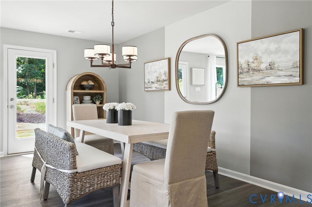 3505 Perrins Hill Way Prince George, VA 23875 - Photo 9 of 24 a dining room with furniture a rug and a window