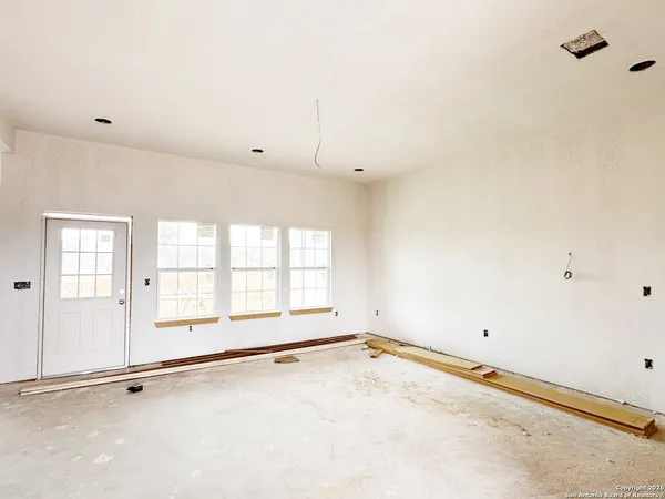 an empty room with a empty space and windows