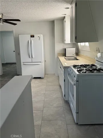 a kitchen with a stove and a refrigerator