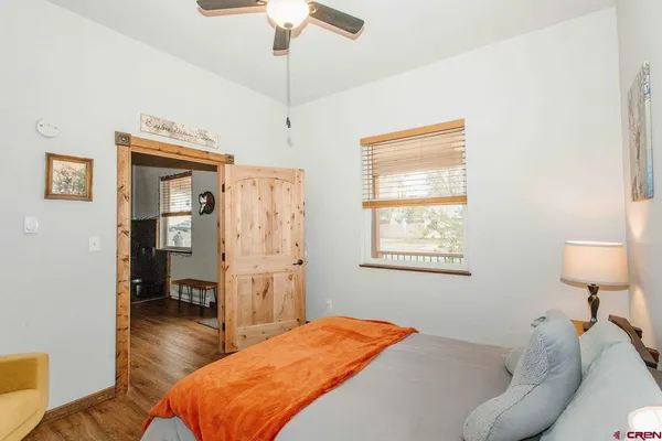 a bedroom with a bed and a chandelier