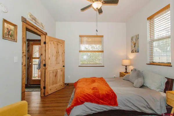 a bedroom with a bed and a window
