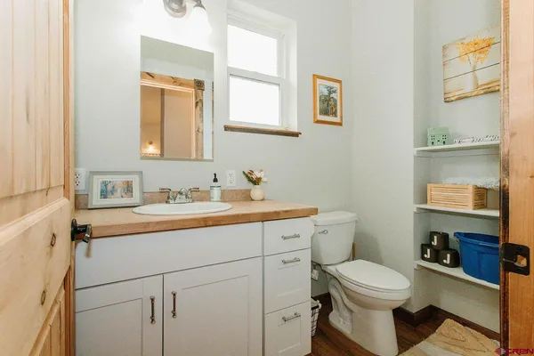 a bathroom with a toilet sink and mirror