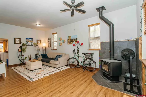 a living room with furniture a window and gym equipment