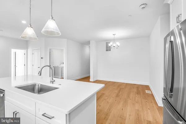 a kitchen with kitchen island a sink appliances and cabinets