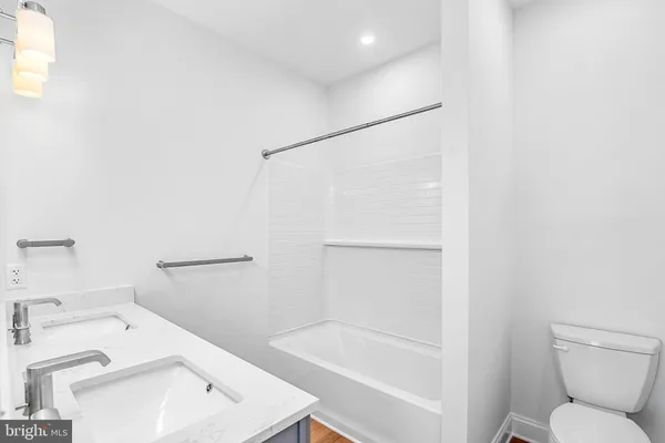 a white bath tub sitting next to a white toilet and sink