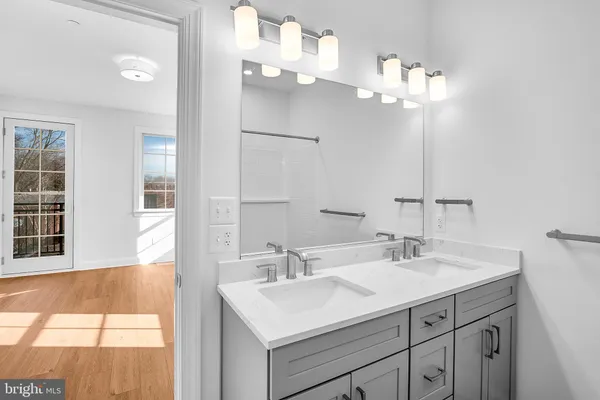 a bathroom with a sink vanity and a mirror
