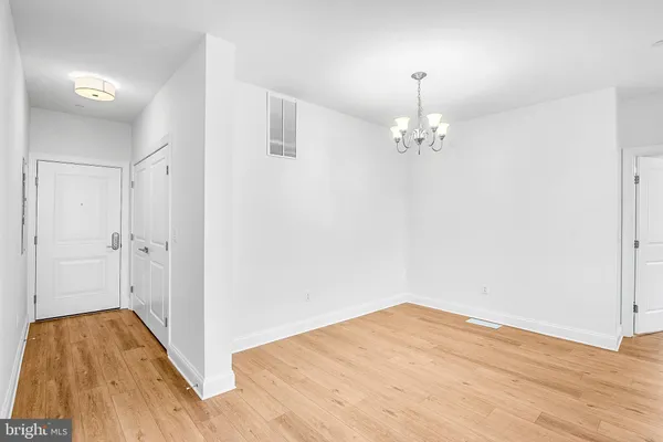 a very nice looking room with wooden floor and a chandelier fan