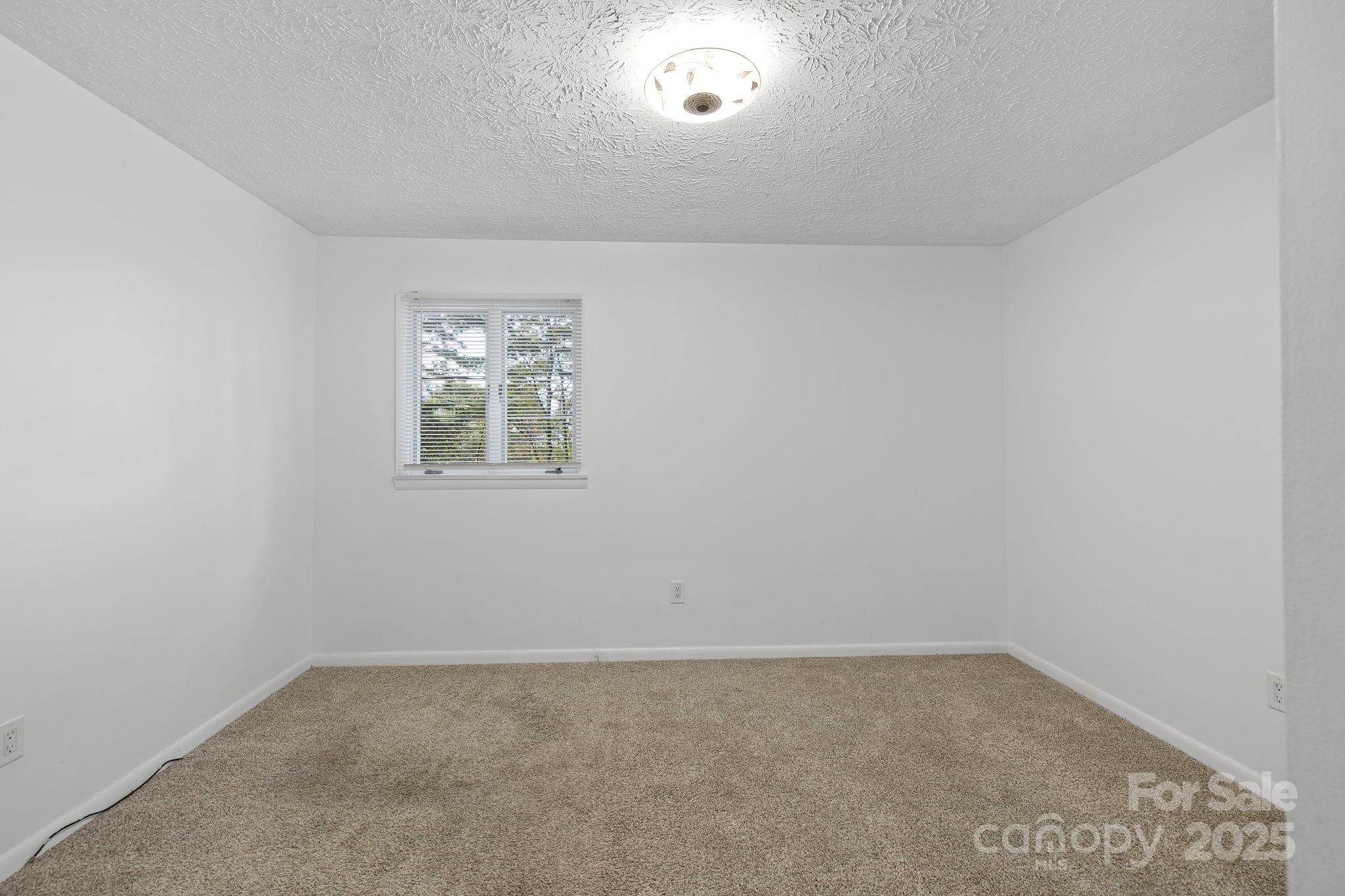 95 Temple Road Black Mountain, NC 28711 - Photo 13 of 30 an empty room with a window