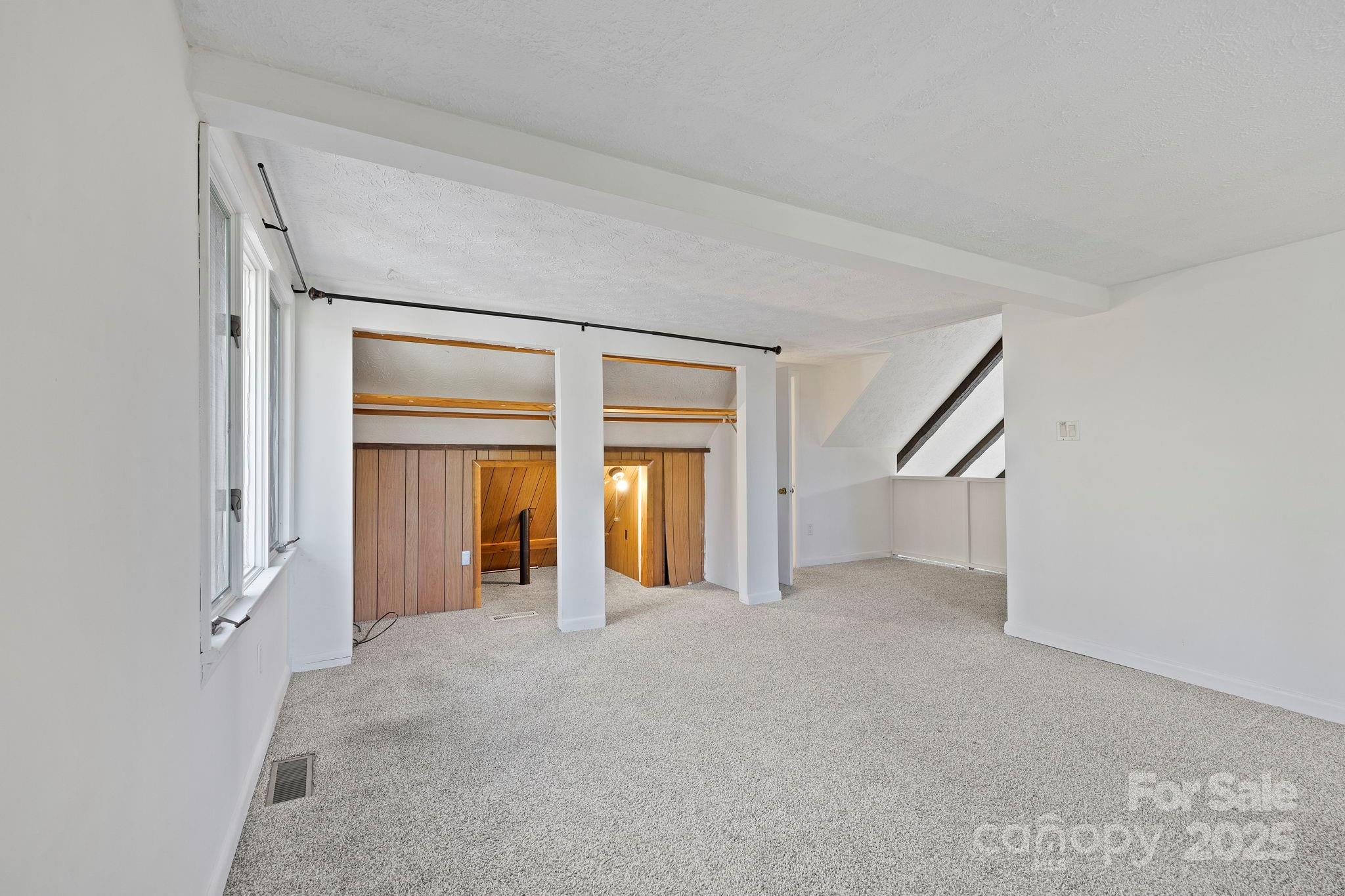 95 Temple Road Black Mountain, NC 28711 - Photo 15 of 30 a view of an empty room with a fireplace and a window