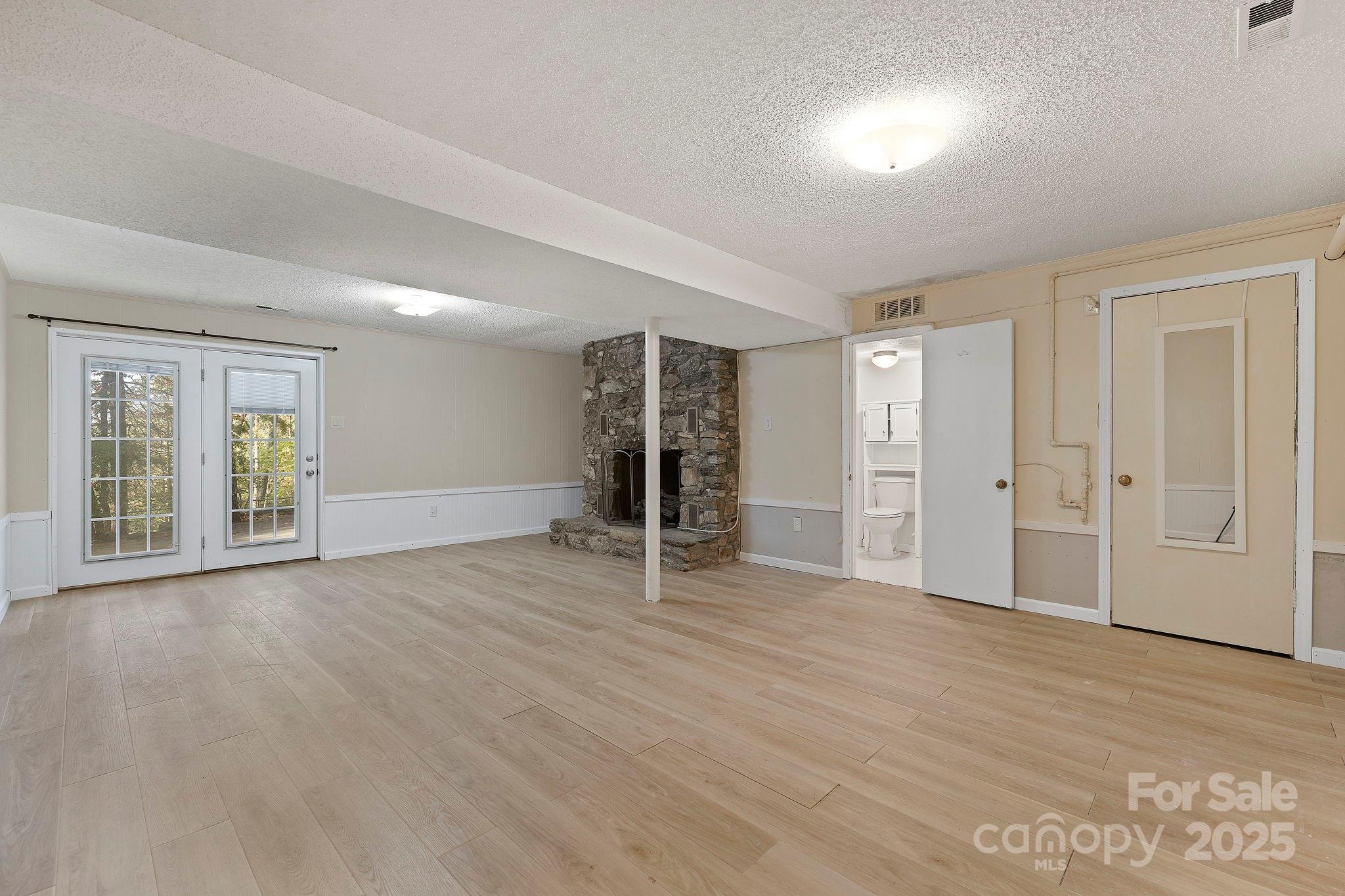 95 Temple Road Black Mountain, NC 28711 - Photo 19 of 30 an empty room with wooden floor and windows