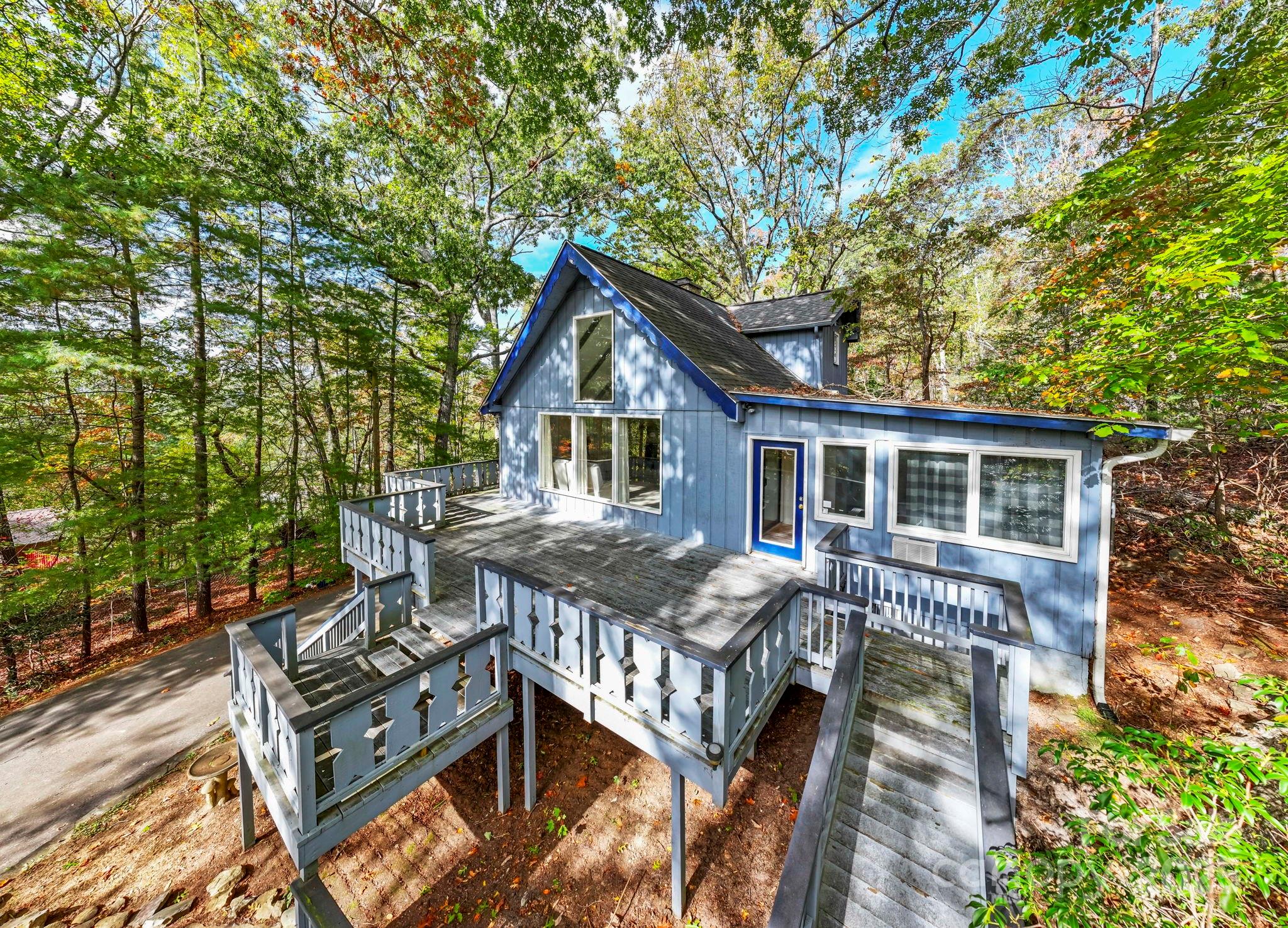 95 Temple Road Black Mountain, NC 28711 - Photo 23 of 30 a front view of house with yard outdoor seating and trees in the background