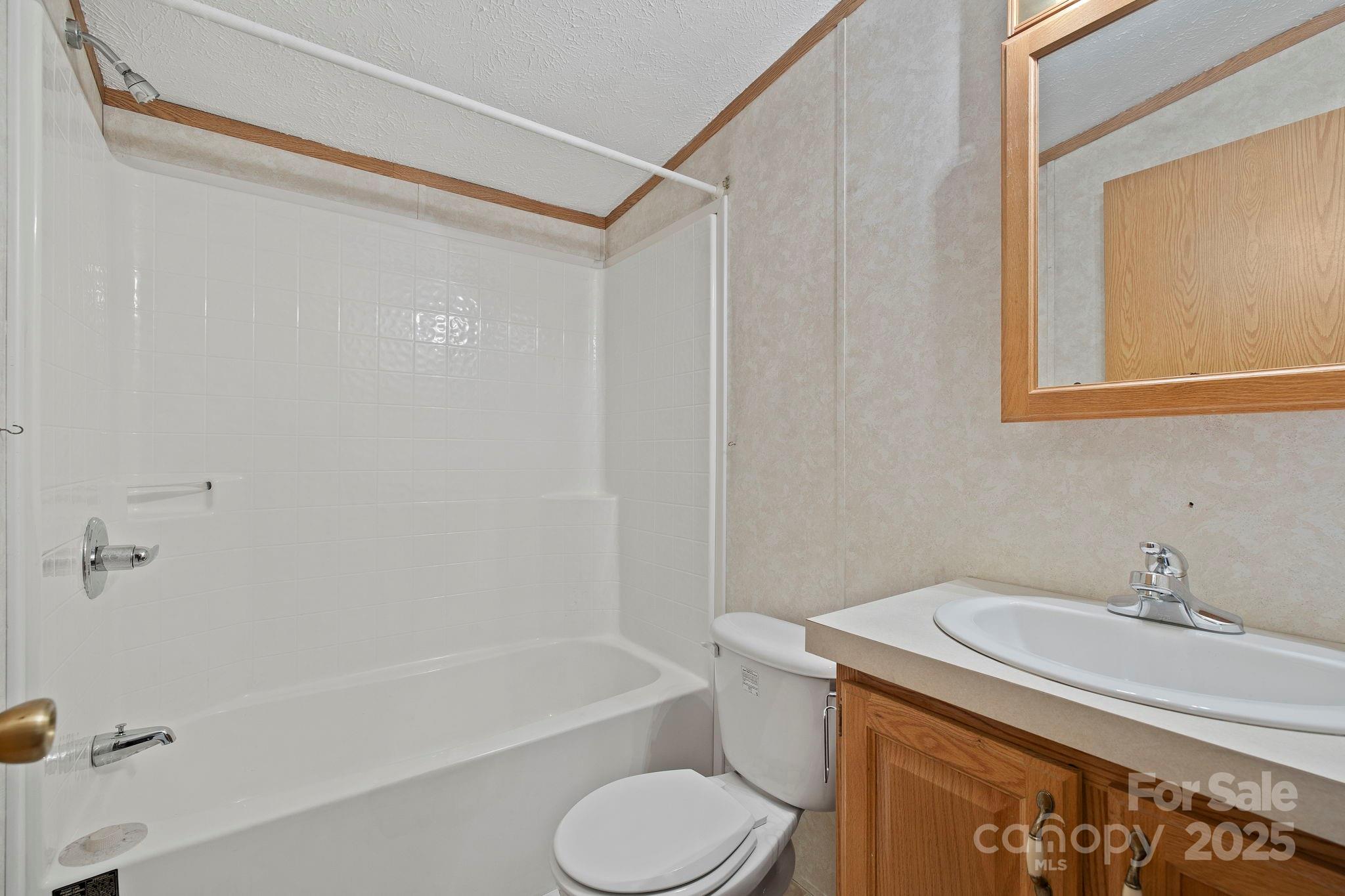 95 Temple Road Black Mountain, NC 28711 - Photo 27 of 30 a bathroom with a sink toilet and shower