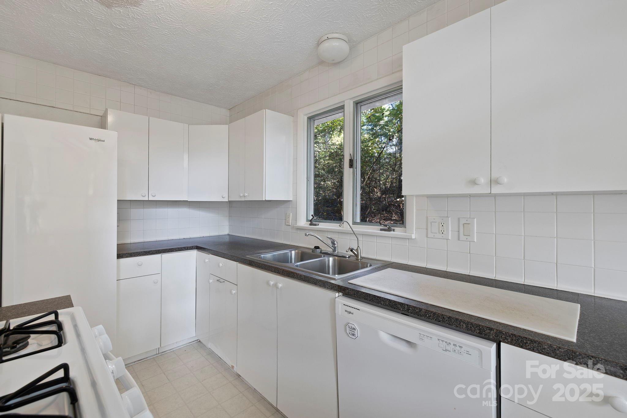 95 Temple Road Black Mountain, NC 28711 - Photo 9 of 30 a kitchen with a sink cabinets and window