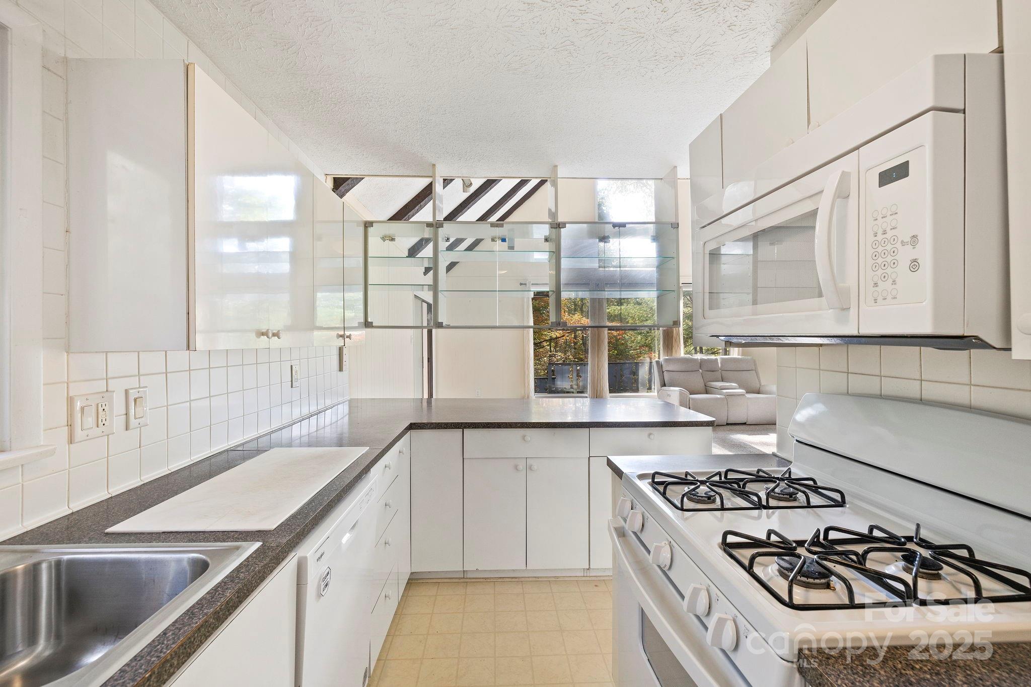 95 Temple Road Black Mountain, NC 28711 - Photo 10 of 30 a kitchen with a stove a sink and a refrigerator