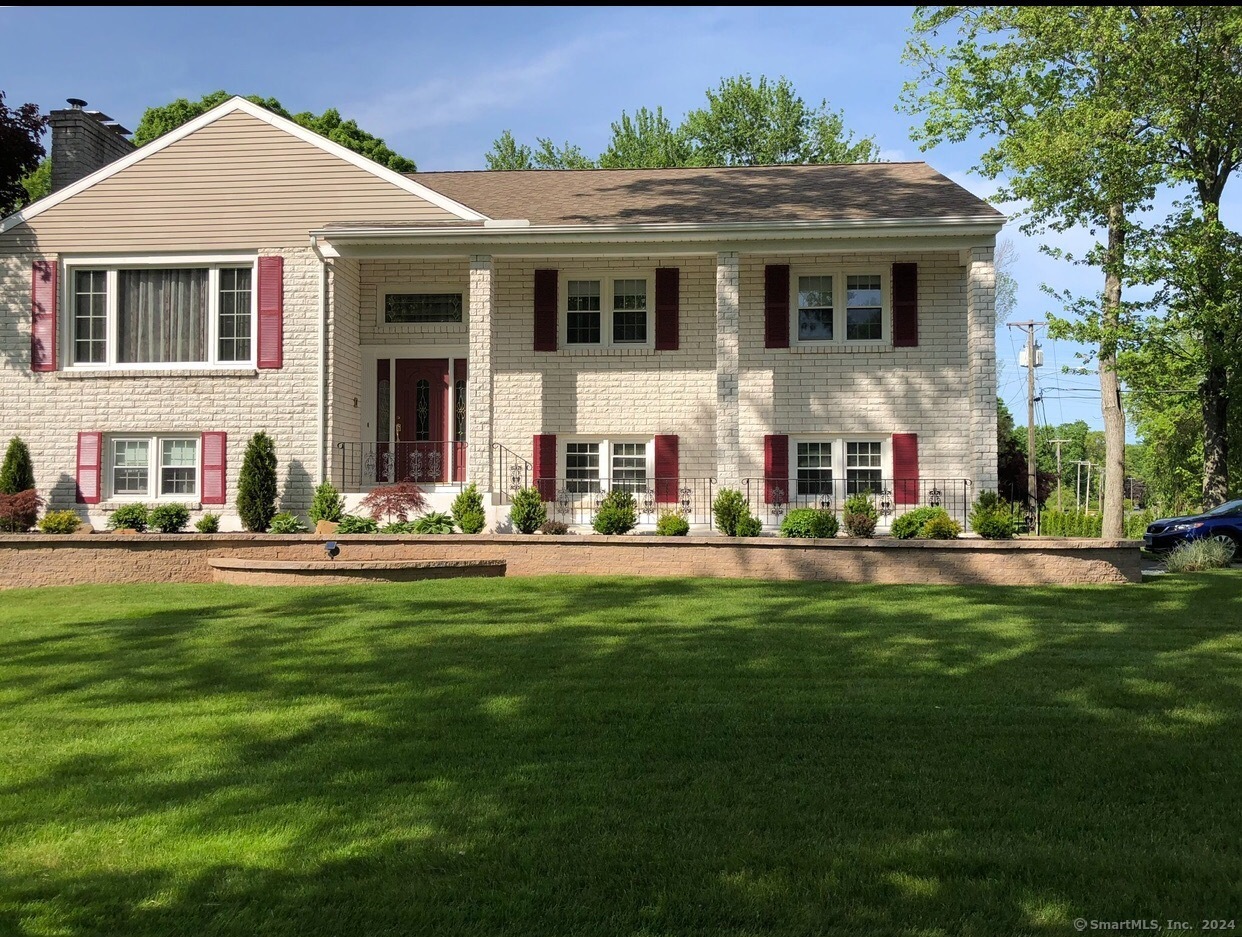 997 Meriden Avenue Southington, CT 06489 - Photo 1 of 1 a view of a white house with a yard potted plants and a table