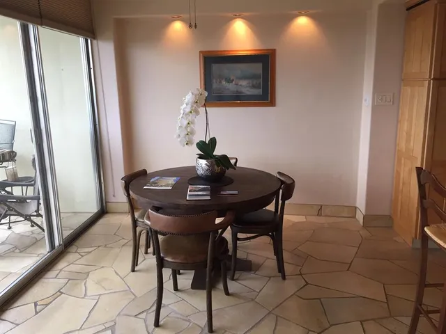 a view of a dining room with furniture and a mirror