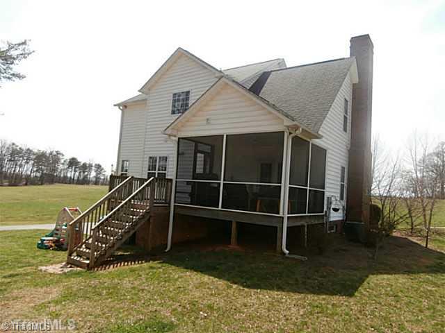 2840 Collinstown Road Westfield, NC 27053 - Photo 13 of 16 Exterior Back. The back shows the screened porch and an additional deck area for the grill.