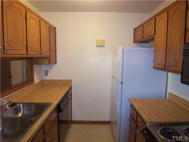 3201 Mill Run Raleigh, NC 27612 - Photo 6 of 12 A compact and efficient kitchen awaits. The refrigerator is a recent purchase and conveys with the home.