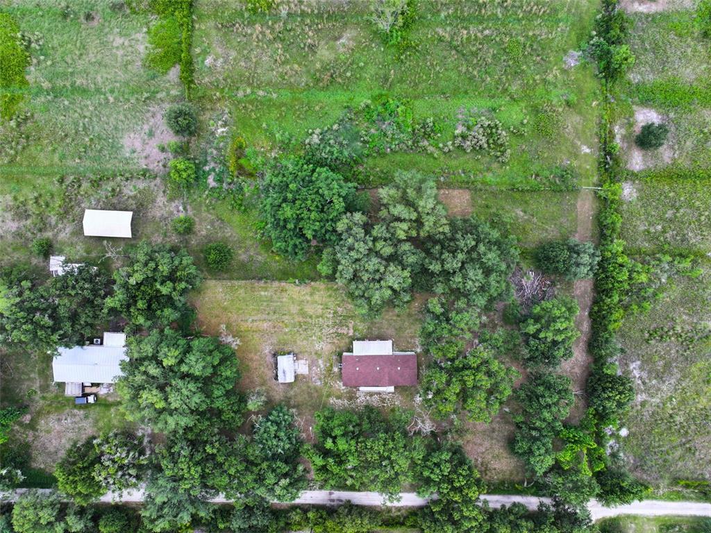 9827 Southeast Hoth Road Arcadia, FL 34266 - Photo 7 of 28 an aerial view of residential house with outdoor space and trees around