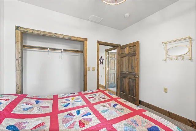 a bedroom with a bed and a mirror