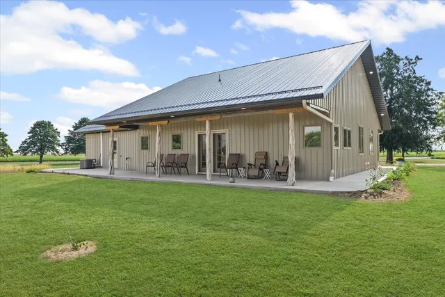 a view of a house with backyard porch and sitting area