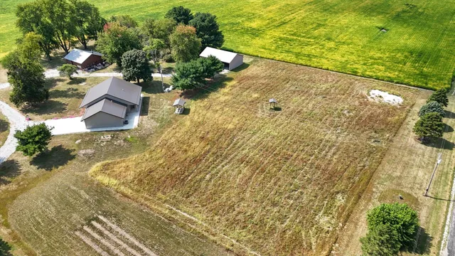 view of a house with a yard and a sitting area