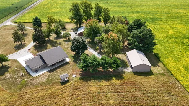 a view of a house with a yard and sitting area