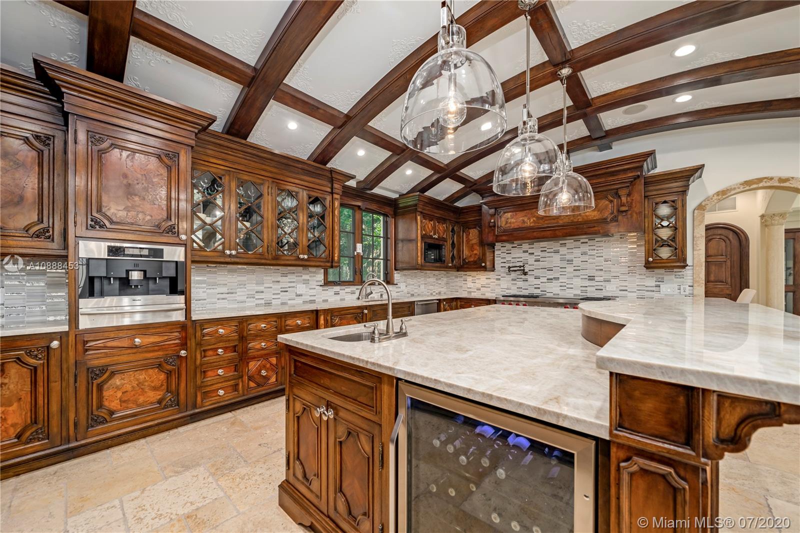 12704 Stonebrook Drive Davie, FL 33330 - Photo 12 of 57 a view of a kitchen with stainless steel appliances granite countertop a sink and wooden cabinets