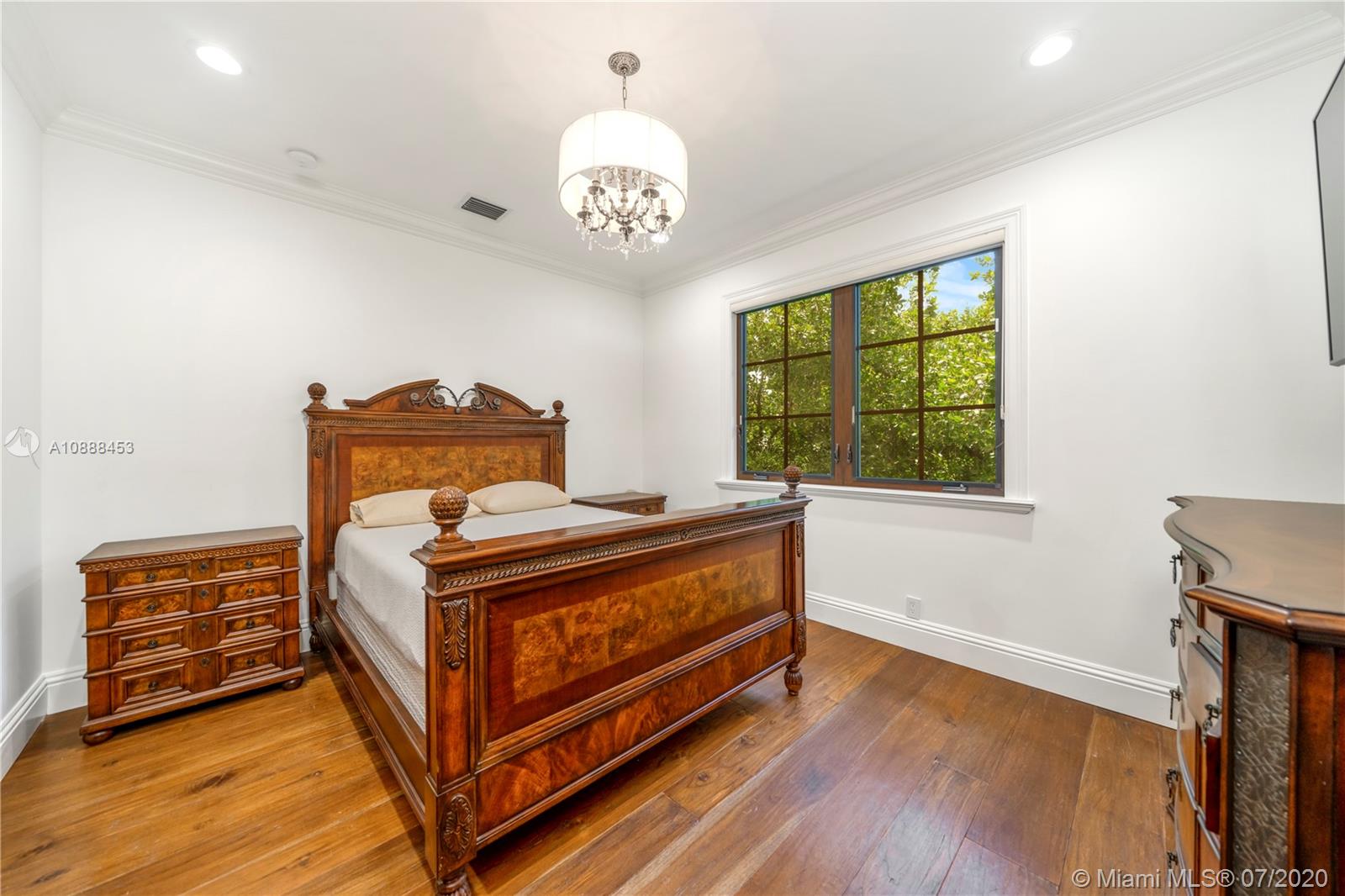 12704 Stonebrook Drive Davie, FL 33330 - Photo 51 of 57 a bed sitting in a bedroom next to a window