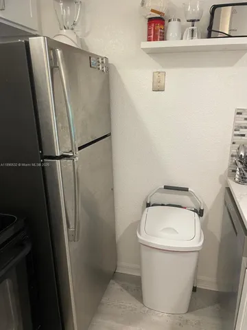 a white toilet sitting next to a white sink and vanity
