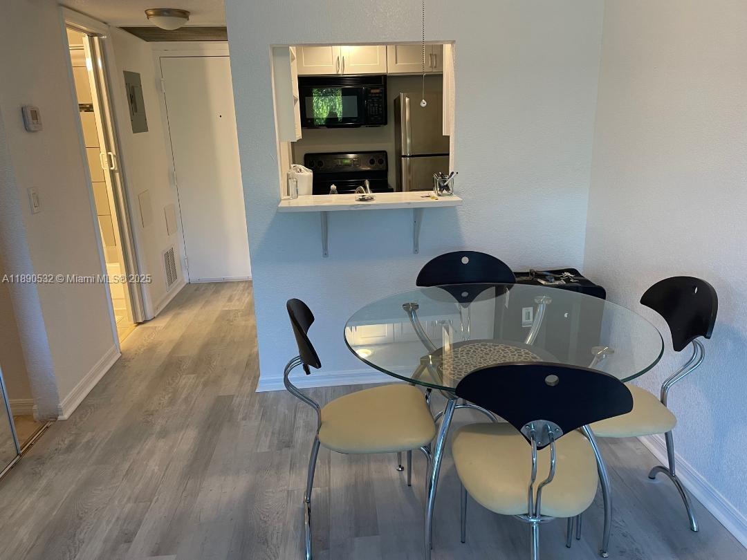 2560 South Ocean Boulevard, Unit 312 Palm Beach, FL 33480 - Photo 13 of 24 a dining room with furniture and window