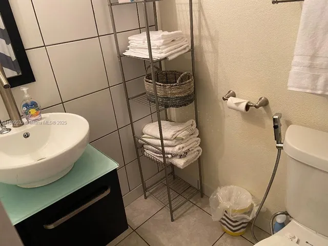 a bathroom with a sink toilet and mirror