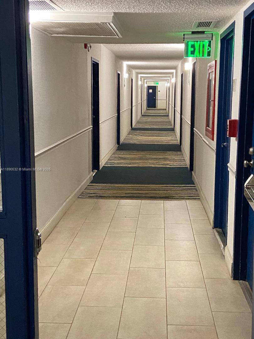 2560 South Ocean Boulevard, Unit 312 Palm Beach, FL 33480 - Photo 17 of 24 a view of a refrigerator in kitchen and an empty room
