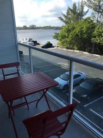 a view of a balcony with table and chairs