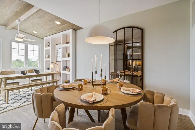 a kitchen with sink refrigerator dining table and chairs