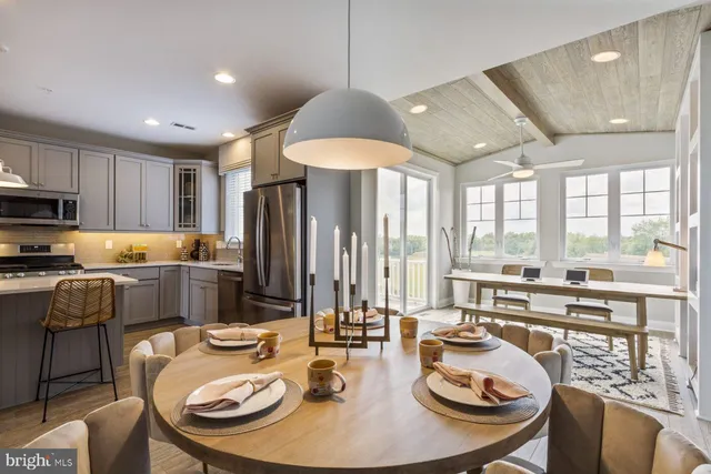 a kitchen with stainless steel appliances granite countertop a sink and wooden floor