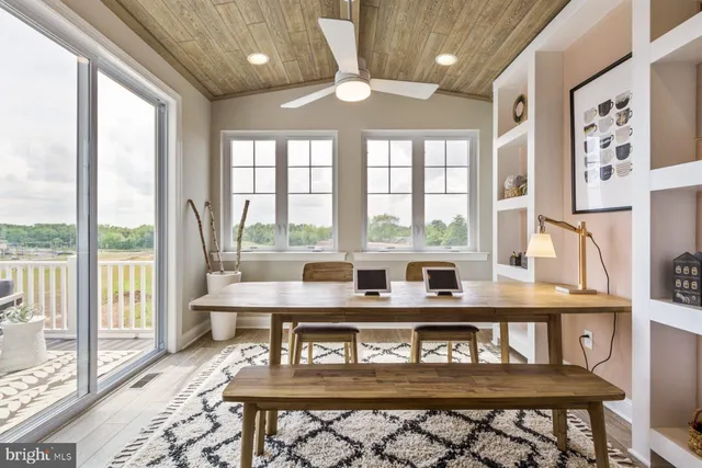 a living room with large windows and furniture
