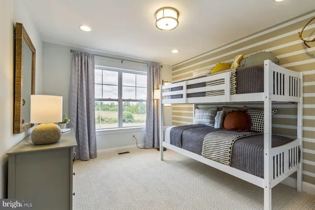 a living room with a bed and furniture