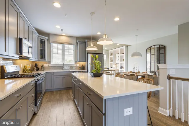 a kitchen with sink a stove and cabinets