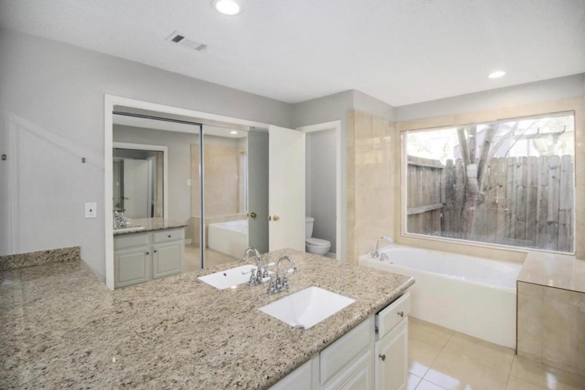 3022 Deer Valley Drive Spring, TX 77373 - Photo 15 of 34 a bathroom with a granite countertop sink and a mirror
