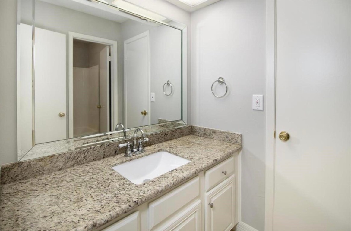 3022 Deer Valley Drive Spring, TX 77373 - Photo 34 of 34 a bathroom with a granite countertop sink and a mirror