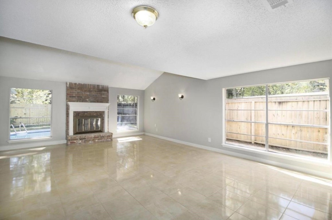 3022 Deer Valley Drive Spring, TX 77373 - Photo 9 of 34 a view of an empty room with a fireplace and a window