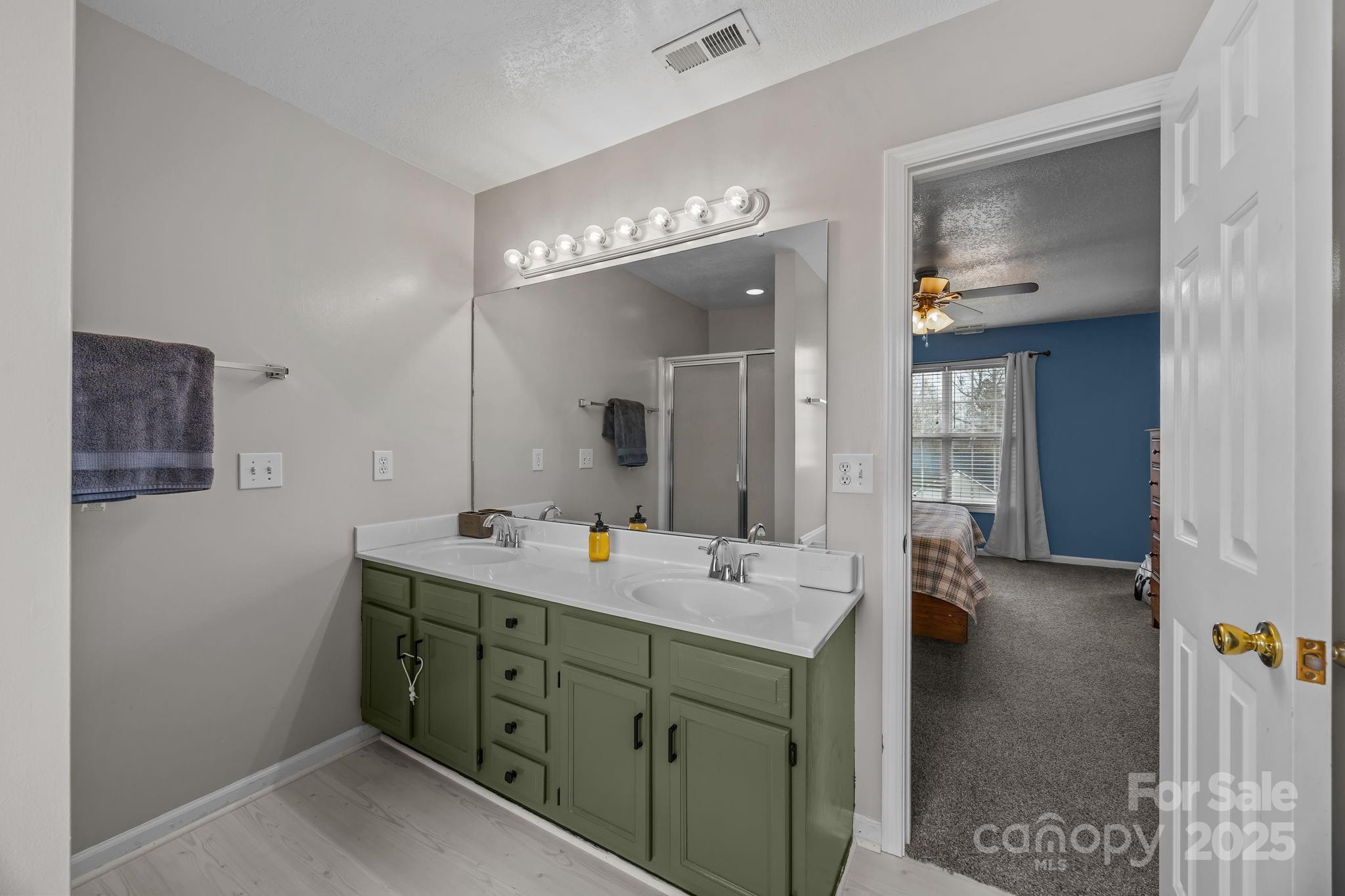 949 Cress School Road Salisbury, NC 28147 - Photo 18 of 46 a bathroom with a double vanity sink and a mirror