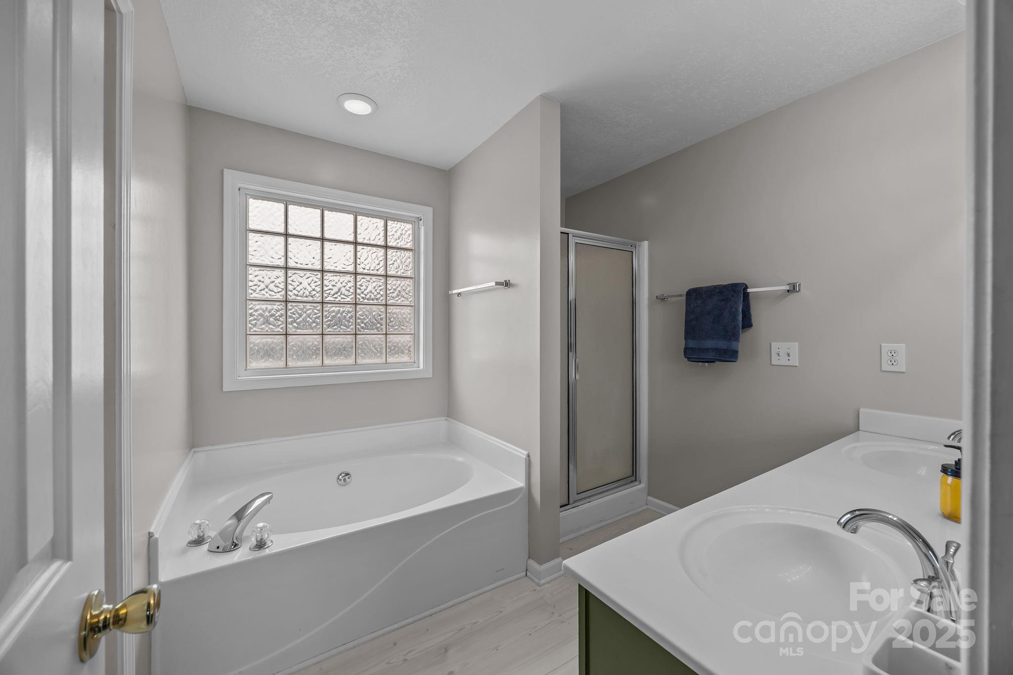949 Cress School Road Salisbury, NC 28147 - Photo 19 of 46 a bathroom with a tub a sink and a shower curtain