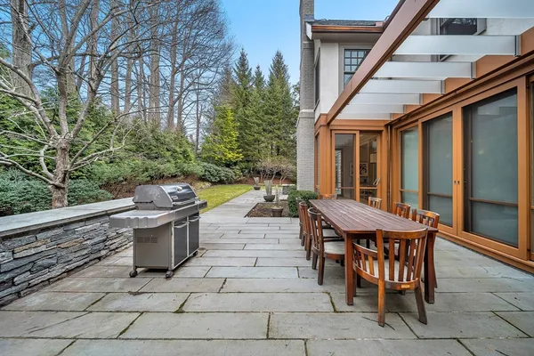 a view of a patio with dining table and chairs with wooden floor and fence