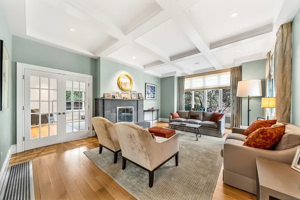a living room with fireplace furniture and a large window