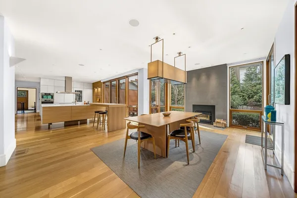 a living room with furniture a wooden floor and next to a window
