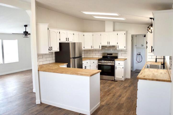 268 County Road Norwood, CO 81423 - Photo 11 of 28 a kitchen with kitchen island a refrigerator stove and sink