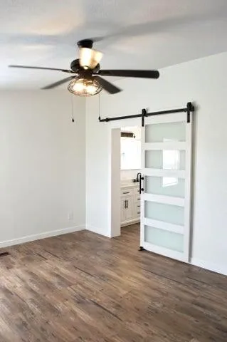 a view of a room with wooden floor